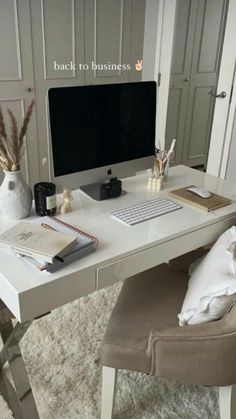 a white desk with a computer on it