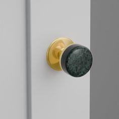 a close up of a door knob with a green marble on the front and side