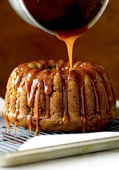 a bundt cake with caramel glaze being drizzled over it