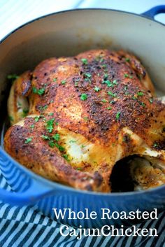 whole roasted cajun chicken in a pan with parsley on top and the words whole roasted cajun chicken above it