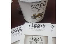 three yogurts sitting on top of each other in front of a cup that says siggis