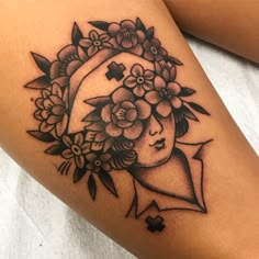 a woman's thigh with flowers and a cross on the side, in black and white