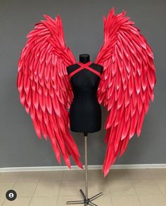 a mannequin with large red wings on it