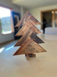 a wooden christmas tree sitting on top of a table