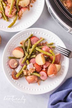 two white plates filled with potatoes, green beans and ham next to an instant pressure cooker