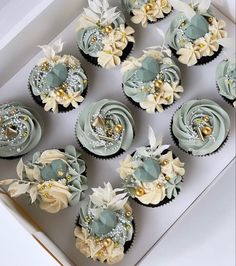 twelve cupcakes in a box decorated with flowers