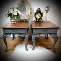 two small tables with flowers and a clock on one side, sitting next to each other