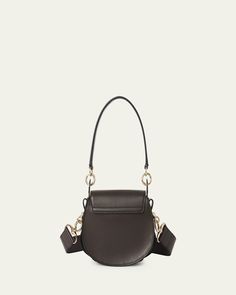 Chloe "Tess" crossbody bag in calf leather    Detachable top handle     Detachable, adjustable crossbody strap    Flap top with oversized ring accent     Approx. 6.7"H x 7.9"W x 2.8"D    Made in Italy Everyday Top Handle Saddle Bag With Branded Hardware, Chic Crossbody Saddle Bag With Branded Hardware, Chic Saddle Bag With Branded Hardware And Crossbody Shape, Evening Saddle Satchel Bag With Branded Hardware, Evening Saddle Shoulder Bag With Branded Hardware, Daily Shoulder Bag With Metal Hardware And Round Handle, Daily Use Shoulder Bag With Metal Hardware, Formal Top Handle Saddle Bag With Branded Hardware, Formal Saddle Bag With Branded Hardware And Top Handle