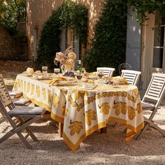 a table set for two outside in the sun