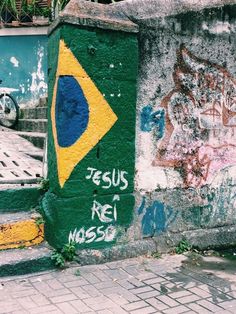 graffiti on the side of a building with a flag painted on it's wall