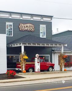 an old red truck parked in front of a restaurant