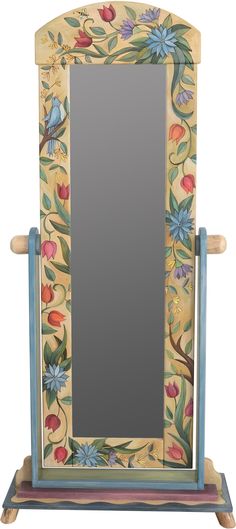 a wooden mirror sitting on top of a stand with flowers and leaves painted on it