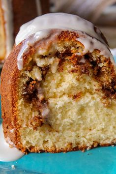 a close up of a piece of cake on a plate with icing and cinnamon