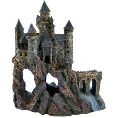 a castle made out of rocks with water running through the front and side walls, on a white background