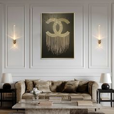 an elegant living room with chandelier and art work on the wall above it