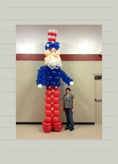 a man standing next to a giant balloon sculpture