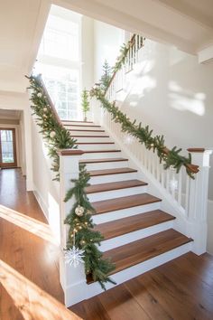 the stairs are decorated with garland and pine cones