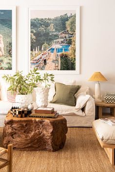 a living room filled with furniture and pictures on the wall above it's coffee table