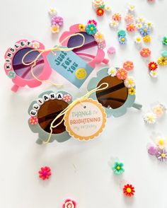 the sunglasses are decorated with colorful flowers and paper tags that say thank you brontoine