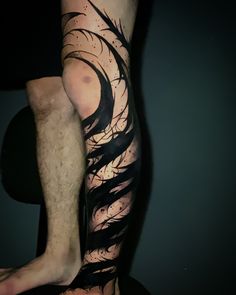 a man's leg with black ink on it