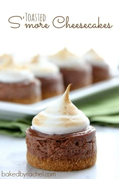 there are several desserts on the table with white frosting and brown icing