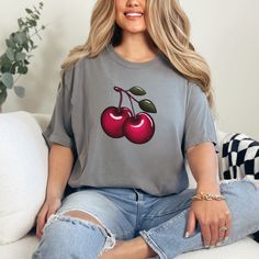 The cozy, oversized Comfort Colors t-shirt boasts a vibrant cluster of juicy red cherries, perfect for summer harvests and Cherry Festivals. If cherries are your fruit of choice, then this shirt is tailor-made for you. Available in t shirt colors, White, Crunchberry, Red and Grey.  .: The Comfort Colors 1717 tee is made with medium fabric (6.1 oz/yd² (206.8 g/m consisting of high quality, 100% ring-spun US cotton for long-lasting comfort. .: The relaxed fit keeps the wearer comfy in both casual and semi-formal settings while the crew neckline delivers that classic, neat style which makes it perfect for accessorizing.  .: The pre-shrunk fabric ensures a consistently great fit. Check all available sizes in our Comfort Colors 1717 size chart.  .: All Comfort Colors 1717 shirts feature pre-shr Trendy Crew Neck T-shirt With Cherry Print, Trendy Summer Tops With Cherry Print, Red Fruit Print Tops For Summer, Trendy Cherry Print Tops For Summer, Red Fruit Print Top For Spring, Casual Cherry Summer Tops, Cherry Short Sleeve Tops For Summer, Casual Red Cherry Print Tops, Trendy Cherry Summer Tops