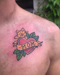 a man with a tattoo on his chest has a heart and flower in the middle