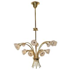 a brass chandelier with glass flowers on it