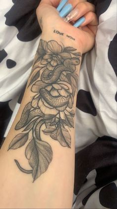 a woman's arm with a flower tattoo on it and the words love you