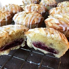 several pastries sitting on top of a cooling rack with icing and crumbs