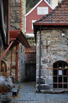 an old stone building with a cross on the door