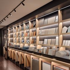 the interior of a store with many bookshelves and lamps on display in front of them