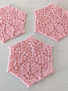 three crochet diamonds coasters made by cootie in pink and white