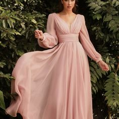 This Dreamy Chiffon Gown Features A Layered A-Line Skirt Gathered At The Waist. Sheer Long Sleeves Drape The Arms Up To The Gathered Deep V-Neckline Bodice And Ruched Waistband. The Back Has A Mid-Opening Allowing For Bra Strap Coverage. Color Blush Tags; Wedding Dress Mother Og Brdie Dress Party Dress Formal Long Sleeve Dress Formal Wear Evening Long Dress Black Formla Gown Ball Gown Bridal Collection Summer Wedding Dress Long Chiffon Dress With Sleeves, Formal Dresses Long Elegant Plus Size, Long Tulle Dress With Sleeves, Belle Sleeve Dress, Long Arm Dress, Kotlc Outfits, Tulle Dress With Sleeves, Pastel Dress Formal, Party Gowns Elegant