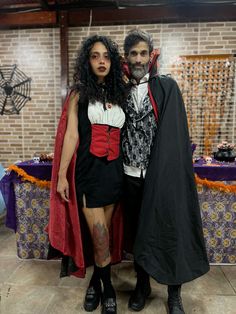 a man and woman dressed up in costumes