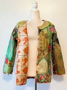 This exceptional cotton jacket with beautiful old embroidery is one-of-a-kind, collector's item. Fully embroidered on all sides, mixed colors which may be worn in all seasons. 3/4 sleeves, fully lined, open duster style. A traditional complex pattern is created from the embroidery. Designed to be worn open, easy fit. This jacket can be worn over a long silk tank dress, palazzo pants, slacks, skirt and even jeans. Jacket crafted by skilled Indian Guajarati Artisans. This jacket represents the true craftsmanship of the region and an object of art. It Is perfect for any event and great for travel. The traditional embroidery patterns are perfect for the boho look of the season. Consider purchasing for a special gift; wedding, anniversary, holiday, etc. One Size: Fits US size 8-12 (Medium) . Ch Fitted Multicolor Outerwear With Intricate Embroidery, Spring Multicolor Embroidered Outerwear, Bohemian Multicolor Outerwear With Intricate Embroidery, Bohemian Long Sleeve Kimono With Intricate Embroidery, Long Sleeve Bohemian Kimono With Intricate Embroidery, Traditional Long-sleeve Outerwear With Embroidered Border, Vintage Long Embroidered Outerwear, Bohemian Long Sleeve Outerwear With Embroidered Border, Traditional Long Patchwork Outerwear