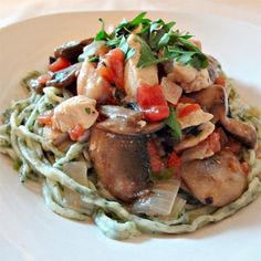 a white plate topped with pasta and mushrooms