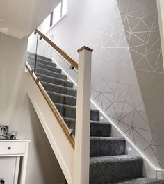 a staircase with grey carpet and white railing