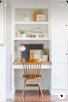 a wooden chair sitting in front of a white book shelf