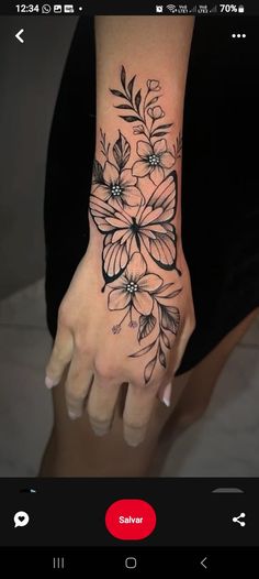 a woman's hand with flowers on it