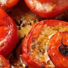 some tomatoes and other food items on a white plate with black stuff around them that looks like something out of space