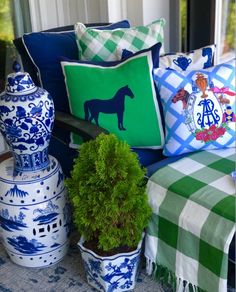 pillows and vases are sitting on a bench