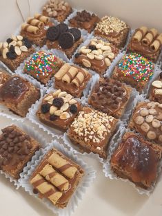 a box filled with lots of different types of desserts on top of each other