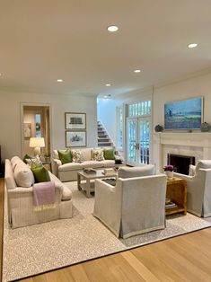 a living room filled with furniture and a fire place in the middle of a room