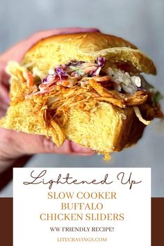 a close up of a person holding a sandwich in their hand with the words slow cooker buffalo chicken sliders