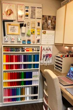 a room with a desk and shelves filled with craft supplies