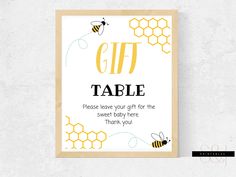 a card with the words gift table on it and bees in honeycombs around it