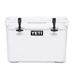 the yeti cooler is white with black handles and latches on it's sides