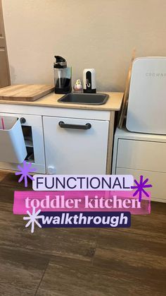 a kitchen with white cabinets and pink stickers on the counter top that says functional toddler kitchen walkthrough