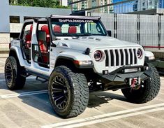 a white jeep parked in a parking lot